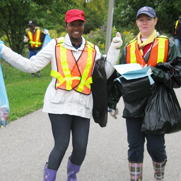 two women celebrate completion of successful shoreline cleanup event