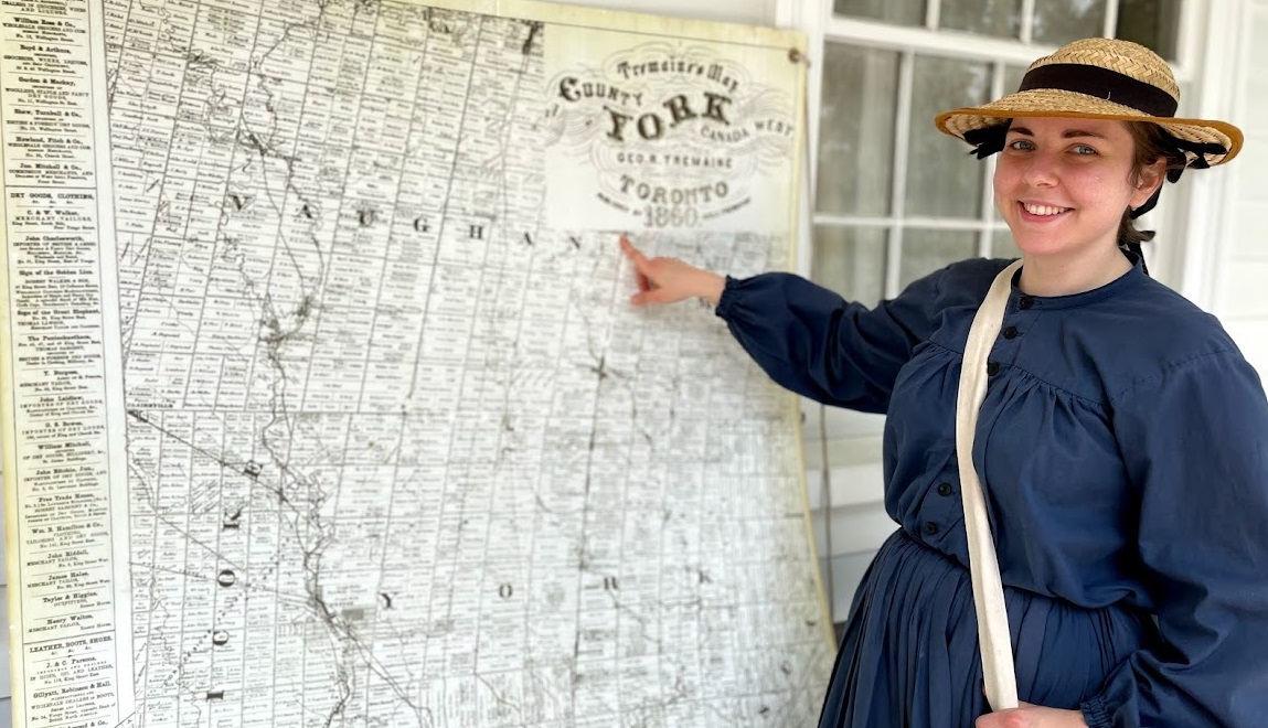 Pioneer woman showing 1860 Toronto map 