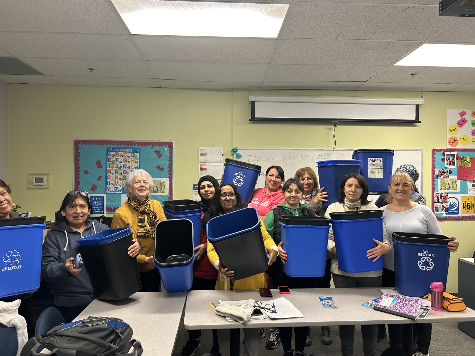 Group of women holding the waste bins they received from Newcomer Centre of Peel.