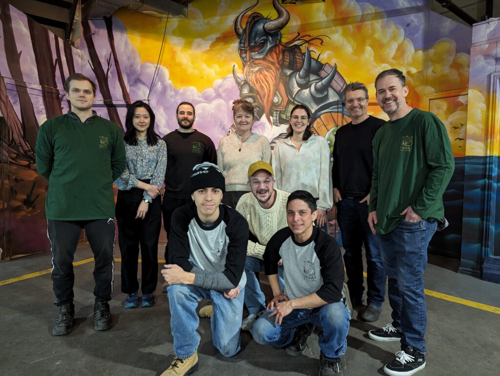 A group shot of 10 people from circular partners against a graffiti art wall