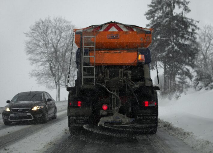 Truck plowing snow in a storm