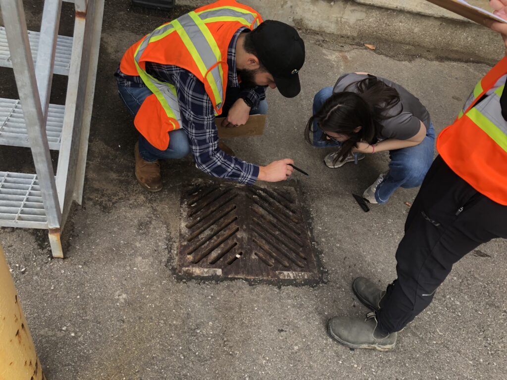 Site assessment staff assessing a storm drain