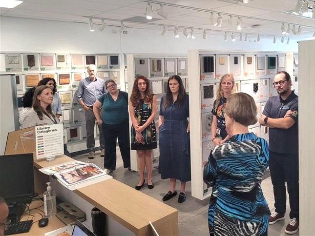 Image of CEC members touring the Sheridan College textile and material sample library. 