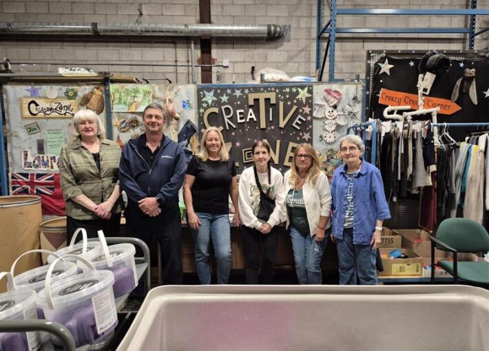 The Creative Zone Staff standing in front of the Creative Zone sign