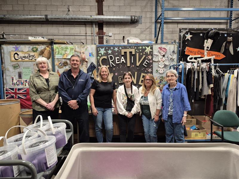 The Creative Zone Staff standing in front of the Creative Zone sign